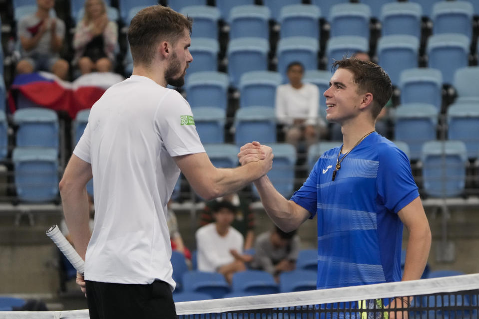 Dalibor Svrcina, right, of the Czech Republic congratulates Germany's Oscar Otte following their Group C match at the United Cup tennis event in Sydney, Australia, Sunday, Jan. 1, 2023. (AP Photo/Mark Baker)