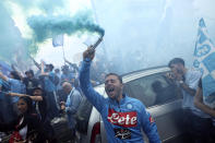 Napoli fans celebrate as they wait for the start of the Serie A soccer match between Napoli and Salernitana, in Naples, Italy, Sunday, April 30, 2021. Napoli fans are already celebrating in anticipation of sealing the club’s first Italian league title since the days when Diego Maradona played for the club. Hours before Napoli’s match against Salernitana later Sunday, fans waved flags in Italy’s green, white and red colors that featured a “3” on them to signify what would be the team’s third Serie A championship after Maradona led the Partenopei to their first two titles in 1987 and 1990. (Alessandro Garofalo/LaPresse via AP)