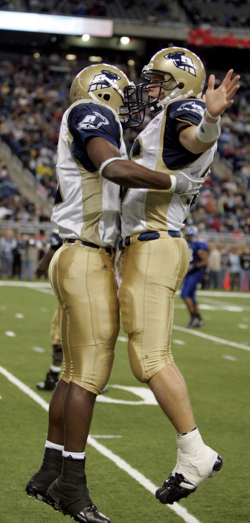 Former University of Akron quarterback Luke Getsy, right, celebrates with receiver Jabari Arthur after a touchdown in the 2005 Motor City Bowl. [Mike Cardew/Beacon Journal]