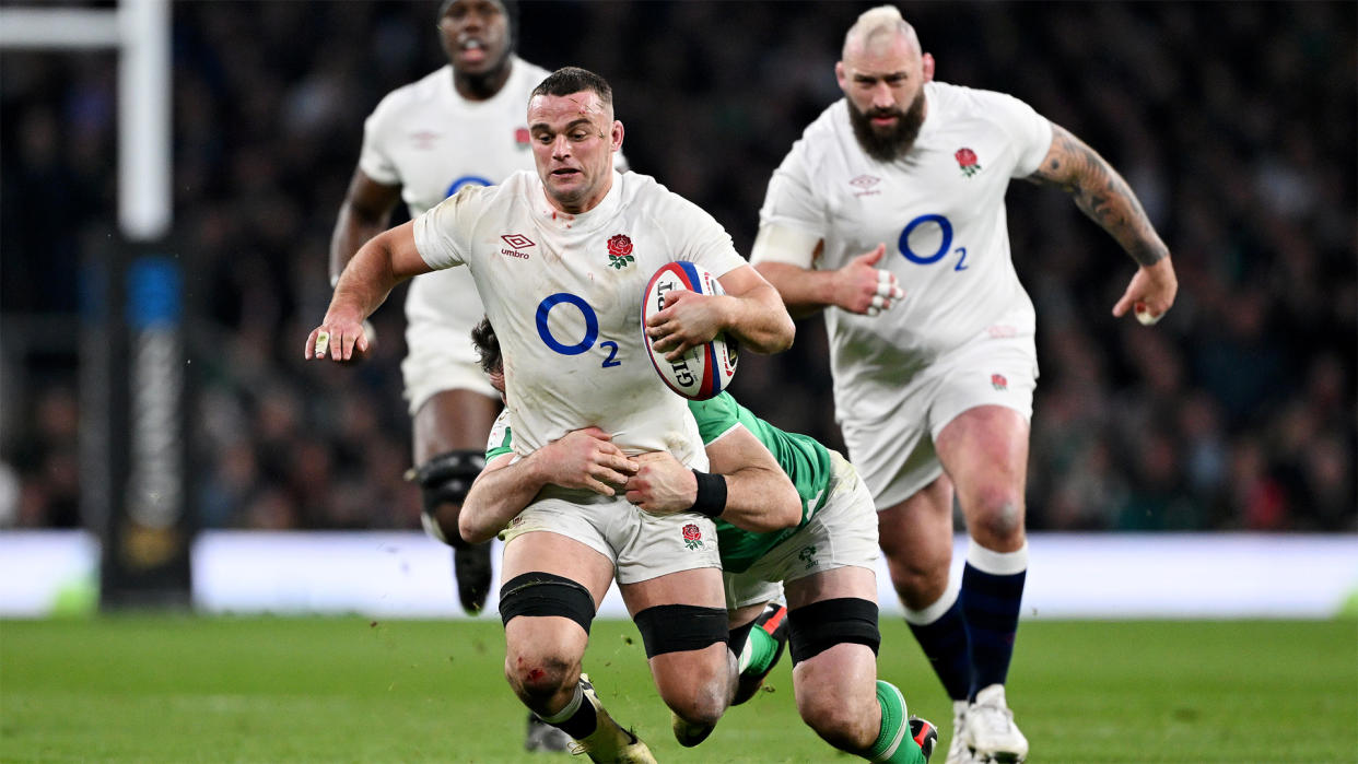  England's Ben Earl falls to the ground after being tackled by Ireland's Peter O'Mahony. 