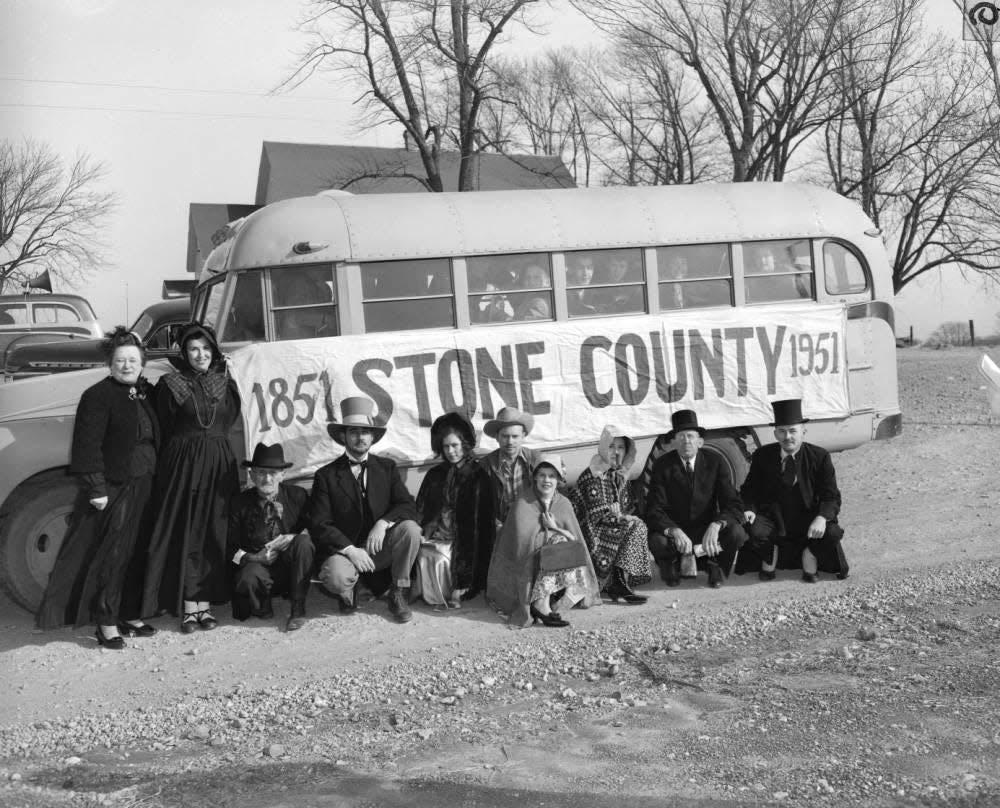 A bus promoting the Stone County Centennial, originally published Feb. 12, 1951. Posing from left to right are Catherine Dolliver, Mrs. Ralph Hilton, Ross Farmer, Joe Ward, Inez Smith, Deputy Sheriff Clifford Smith, Bonnie Bennage, Virginia Peters, Roy Rinner, and Bud Turk.