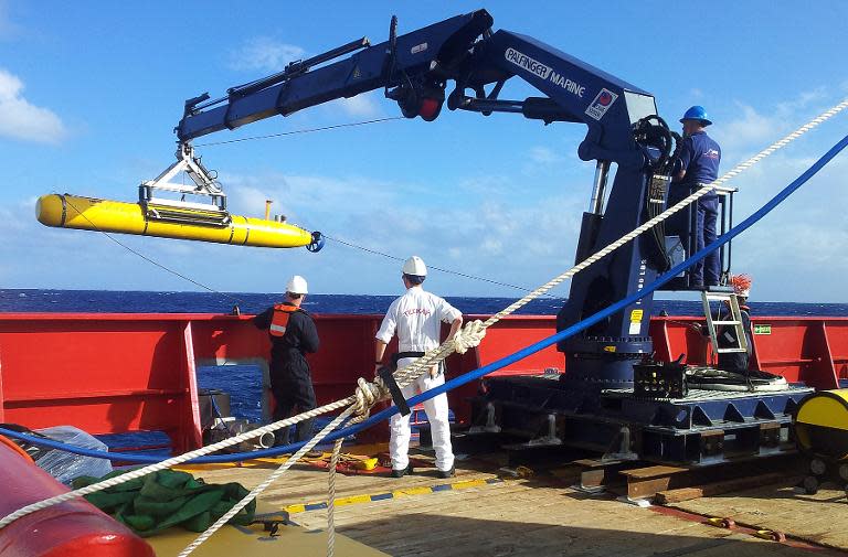 Phoenix International staff test the Artemis autonomous underwater vehicle on the deck of Australian ship Ocean Shield as it searches for missing Malaysia Airlines flight MH370 in the southern Indian Ocean, April 1, 2014