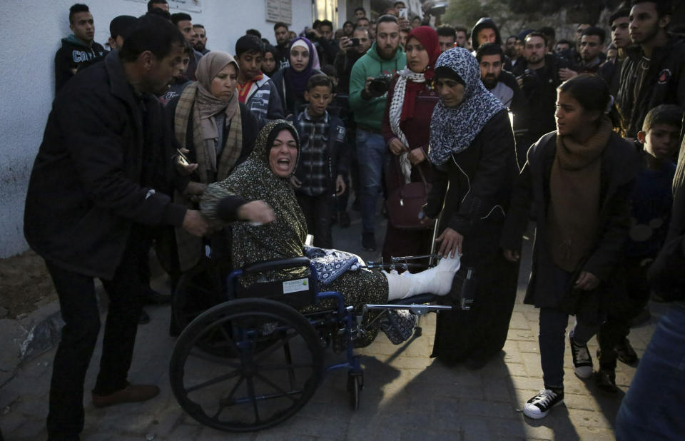 Relatives arrives to the morgue of Shifa hospital to see the body of a woman who was killed by Israeli troops during a protest at the Gaza Strip's border with Israel, in Gaza City, Friday, Jan. 11, 2019. Spokesman Ashraf al-Kidra says the woman was shot in the head Friday at a protest site east of Gaza City. (AP Photo/Adel Hana)