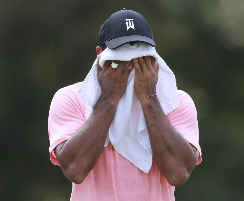 Tiger Woods towels off on the third fairway during the first round of the Tour Championship golf tournament at East Lake Golf Club, in Atlanta, Thursday, Sept. 20, 2018. (Curtis Compton/Atlanta Journal-Constitution via AP)