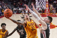 Southern California guard Tre White (22) shoots as Washington State forward Andrej Jakimovski (23) defends during the first half of an NCAA college basketball game Thursday, Feb. 2, 2023, in Los Angeles. (AP Photo/Mark J. Terrill)