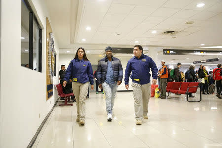 American boxer Mike Tyson (C) is escorted by members of the Investigative Police of Chile (PDI) at the Santiago International Airport in Santiago, Chile November 9, 2017. Courtesy of Policia de Investigaciones de Chile/Handout via REUTERS ATTENTION EDITORS - THIS IMAGE WAS PROVIDED BY A THIRD PARTY.