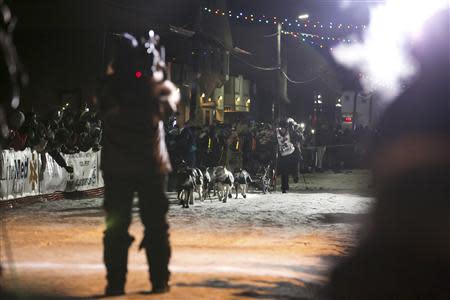 Dallas Seavey runs with his team toward the finish line on the way to his second win during the Iditarod dog sled race in Nome, Alaska, early March 11, 2014. REUTERS/Nathaniel Wilder