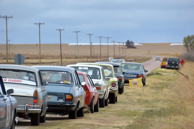 Una pequeña parte del diverso parque automotor del Gran Premio, a la vera de la ruta: dos Peugeot 404, un 504, un Alfa Romeo Sprint, un FIAT 128, un Ford Falcon, un FIAT 1500 y un Renault 18 están a la espera de largar una de las pruebas especiales de la competencia.