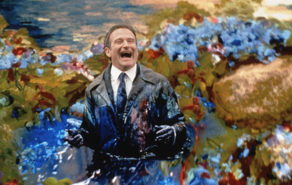 Robin Williams laughing in a pond