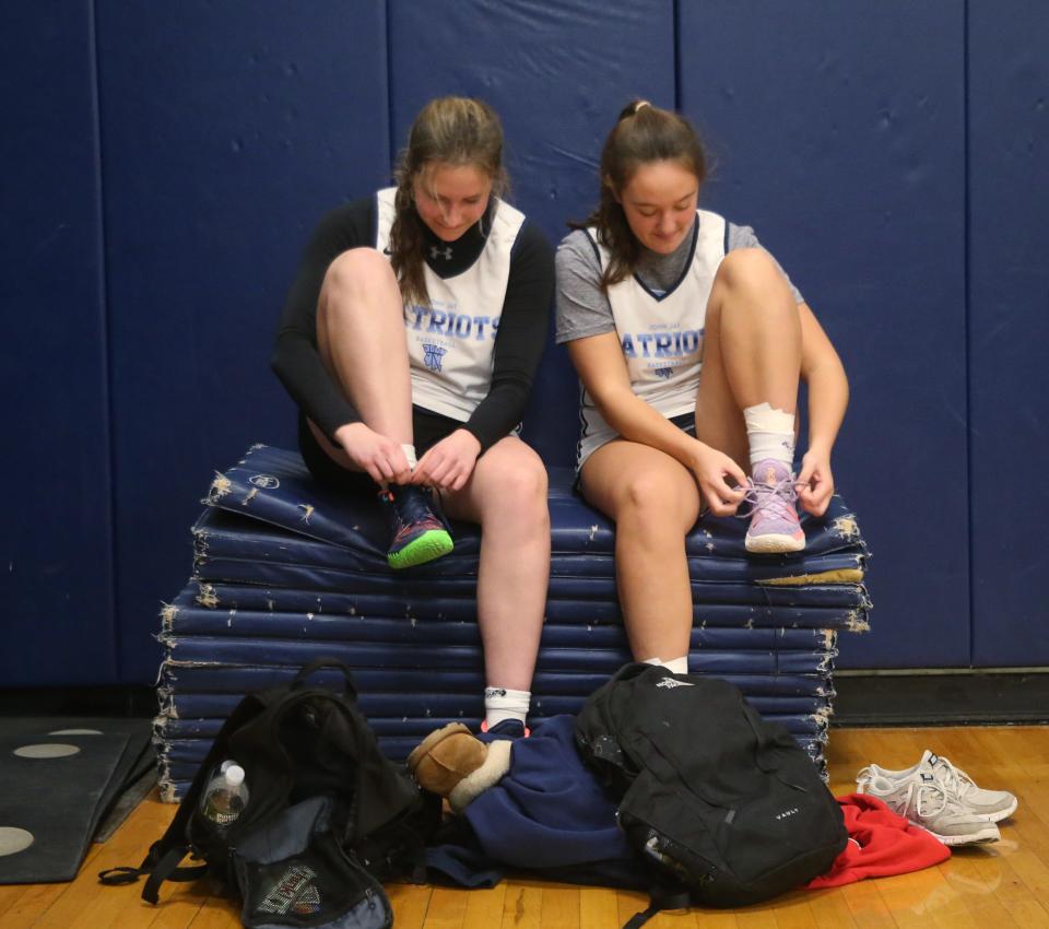 John Jay basketball players, from left, Gabby Sweeny and Grace Kennedy change their shoes after a scrimmage versus Red Hook on November 30, 2023.