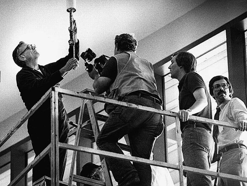Investigators examine one of the rods where the skywalks were hung at the Hyatt in July 1981.