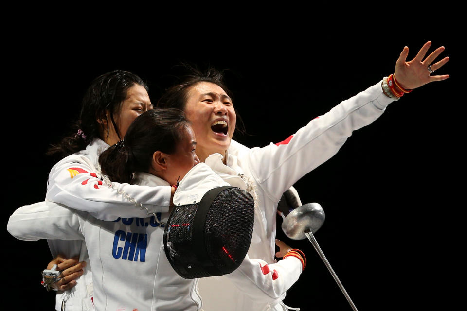 LONDON, ENGLAND - AUGUST 04: Members of Team China celebrate their 39-25 win over Korea during their Gold Medal Match in the Women's Epee Team Fencing Finals on Day 8 of the London 2012 Olympic Games at ExCeL on August 4, 2012 in London, England. (Photo by Hannah Johnston/Getty Images)