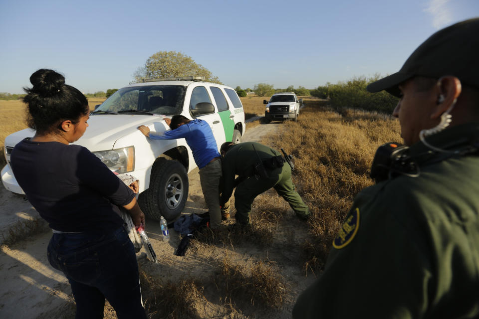 FILE - Border Patrol agents hold a group thought to have entered the United States illegally, near McAllen, Texas, along the U.S.-Mexico border, Nov. 6, 2019. The American Civil Liberties Union is making plans to fight the immigrant raids and mass deportations that former President Donald Trump has promised if he were to win a second term. (AP Photo/Eric Gay, File)