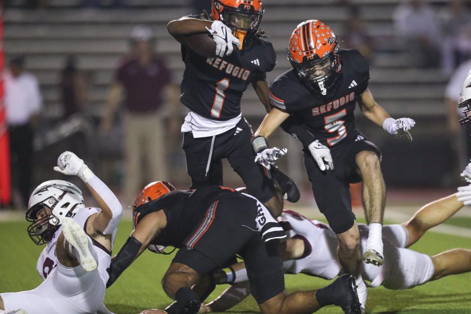 Refugio's Ernest Campbell is tackled while attempting to vault over Ganado during the Region IV-2A Division I finals at Memorial Stadium on Thursday, Nov. 30, 2023, in Victoria, Texas.