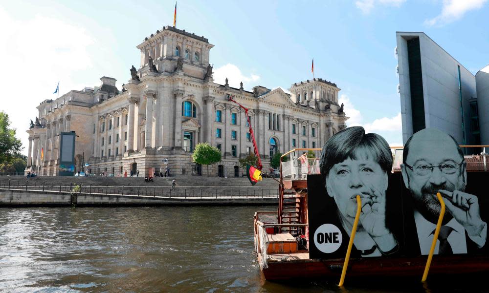 A boat with a placard featuring the German chancellor, Angela Merkel, and SPD leader, Martin Schulz, passes the Bundestag in September.