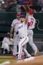 Texas Rangers first baseman Nathaniel Lowe reaches out for the throw as Los Angeles Angels' Shohei Ohtani reaches on a fielder's choice during the sixth inning of a baseball game Wednesday, May 18, 2022, in Arlington, Texas. Tyler Wade was out at second on the play. (AP Photo/Tony Gutierrez)