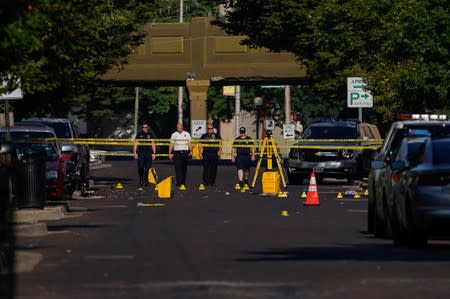 Officials investigate the scene after a mass shooting in Dayton