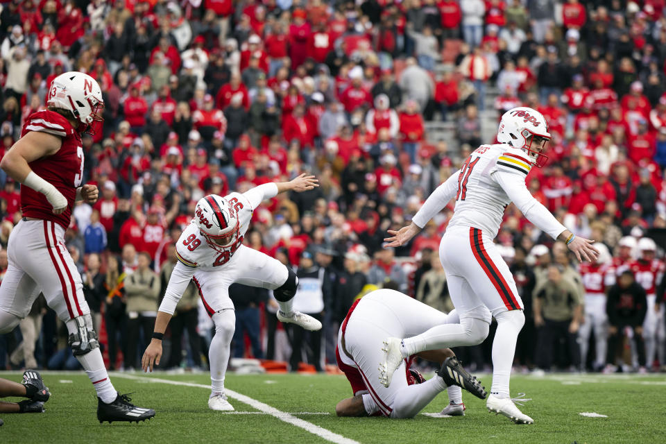 Maryland kicker Jack Howes, right, and Colton Spangler, second left, celebrate after Howes kicked the game winning field goal against Nebraska's Nick Henrich, left, and Elijah Jeudy during the second half of an NCAA college football game Saturday, Nov. 11, 2023, in Lincoln, Neb. Maryland defeated Nebraska 13-10. (AP Photo/Rebecca S. Gratz)