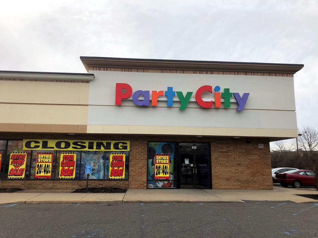 Party City store with closing signs pasted on windows