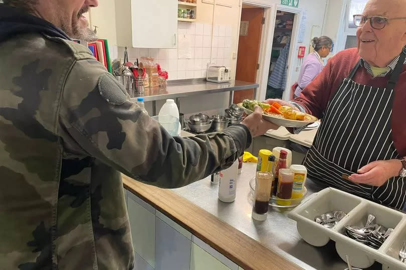 Julian getting his lunch from one of the volunteers at the drop-in centre