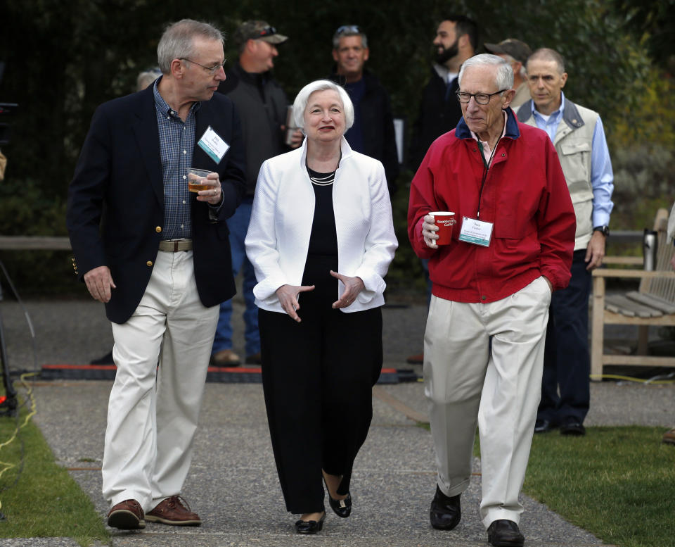 FILE - In this Aug. 26, 2016, file photo Federal Reserve Chair Janet Yellen, center, walks with Stanley Fischer, right, vice chairman of the Board of Governors of the Federal Reserve System, and Bill Dudley, the president of the Federal Reserve Bank of New York, before Yellen's speech to the annual invitation-only conference of central bankers from around the world, at Jackson Lake Lodge in Grand Teton National Park, north of Jackson Hole, Wyo. (AP Photo/Brennan Linsley, File)