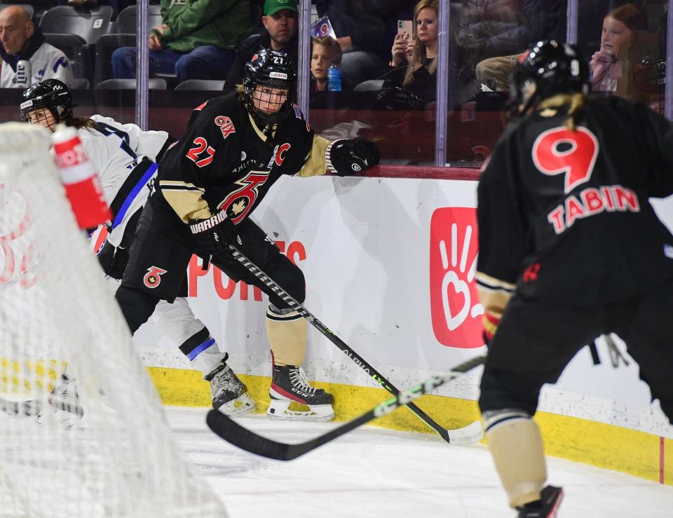 Brighton native Shiann Darkangelo (27) of the Toronto Six works behind the net during the Isobel Cup championship game against the Minnesota Whitecaps at Mullett Arena on March 26, 2023 in Tempe, Ariz.