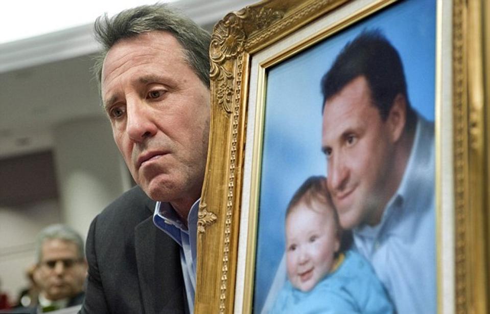 Neil Heslin with a framed photograph of his murdered son Jesse (file photo) (AP)