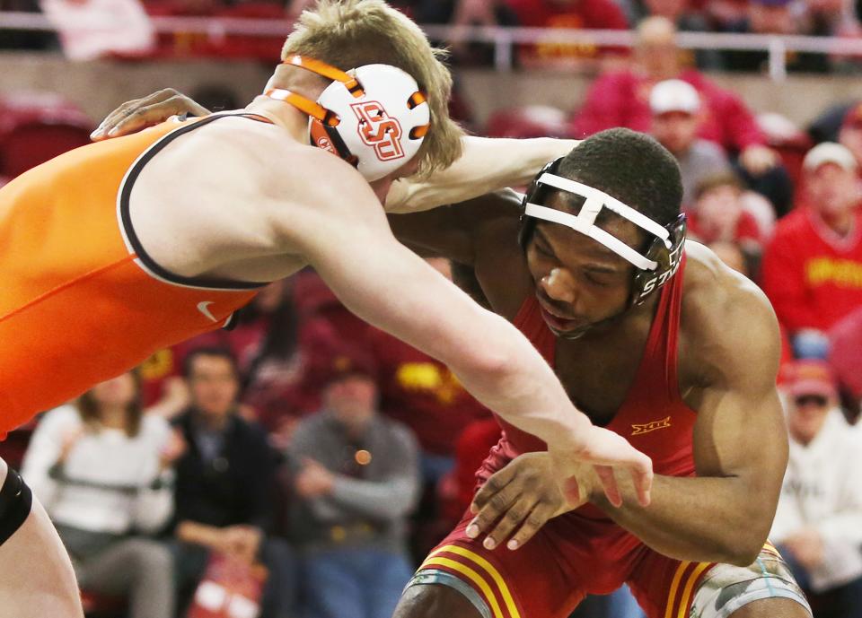 Iowa State's Paniro Johnson, right, and Oklahoma State's Victor Voinovich wrestle at Hilton Coliseum on Jan. 29 in Ames.
