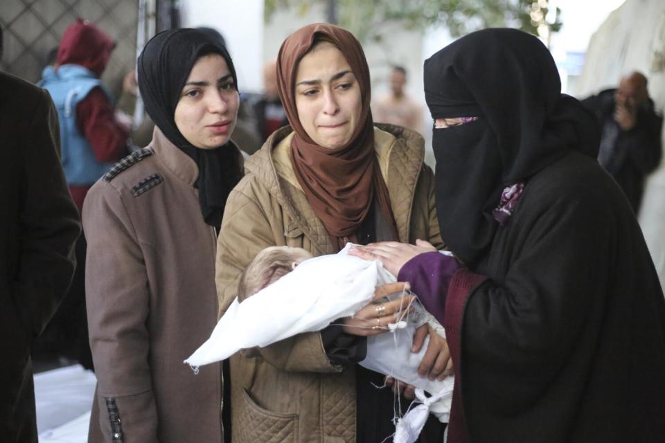 Palestinians mourn a child killed in the Israeli bombardment of the Gaza Strip