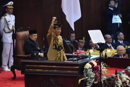 Indonesia President Joko Widodo gestures while delivering a speech in front of the parliament members ahead of Independence Day, at the parliament building in Jakarta