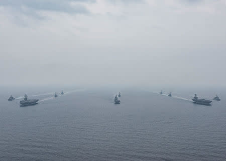 U.S. Navy aircraft carriers USS Ronald Reagan (front) and USS Carl Vinson and (back R) sail with their strike groups and Japanese naval ships JS Hyuga (C) and JS Ashigara during training in the Sea of Japan, June 1, 2017. U.S. Navy/Mass Communication Specialist 2nd Class Z.A. Landers/Handout via REUTERS