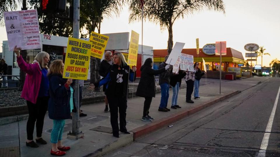 Grover Beach residents protest a proposed 91.7% water rate increase over the next five years, before the Grover Beach City Council meeting on Nov. 13, 2023. Some residents said they have started knocking on doors, encouraging their neighbors to write letters of protest against the project.