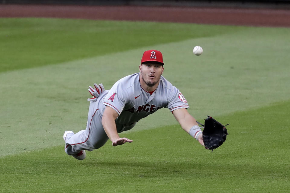 Los Angeles Angels center fielder Mike Trout dives for, but misses, a fly ball from Seattle Mariners' J.P. Crawford for a single in the third inning of a baseball game Wednesday, Aug. 5, 2020, in Seattle. (AP Photo/Elaine Thompson)