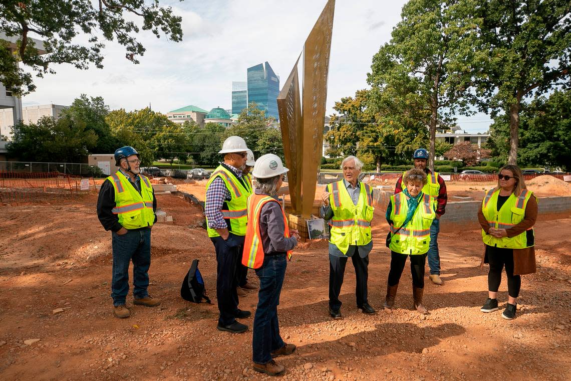 David Warren, center, co-chair of the North Carolina Freedom Park, talks with a group as they gather to view the newly installed Beacon of Freedom, the centerpiece sculpture in the North Carolina Freedom park on Thursday, September 29, 2022 in Raleigh, N.C.