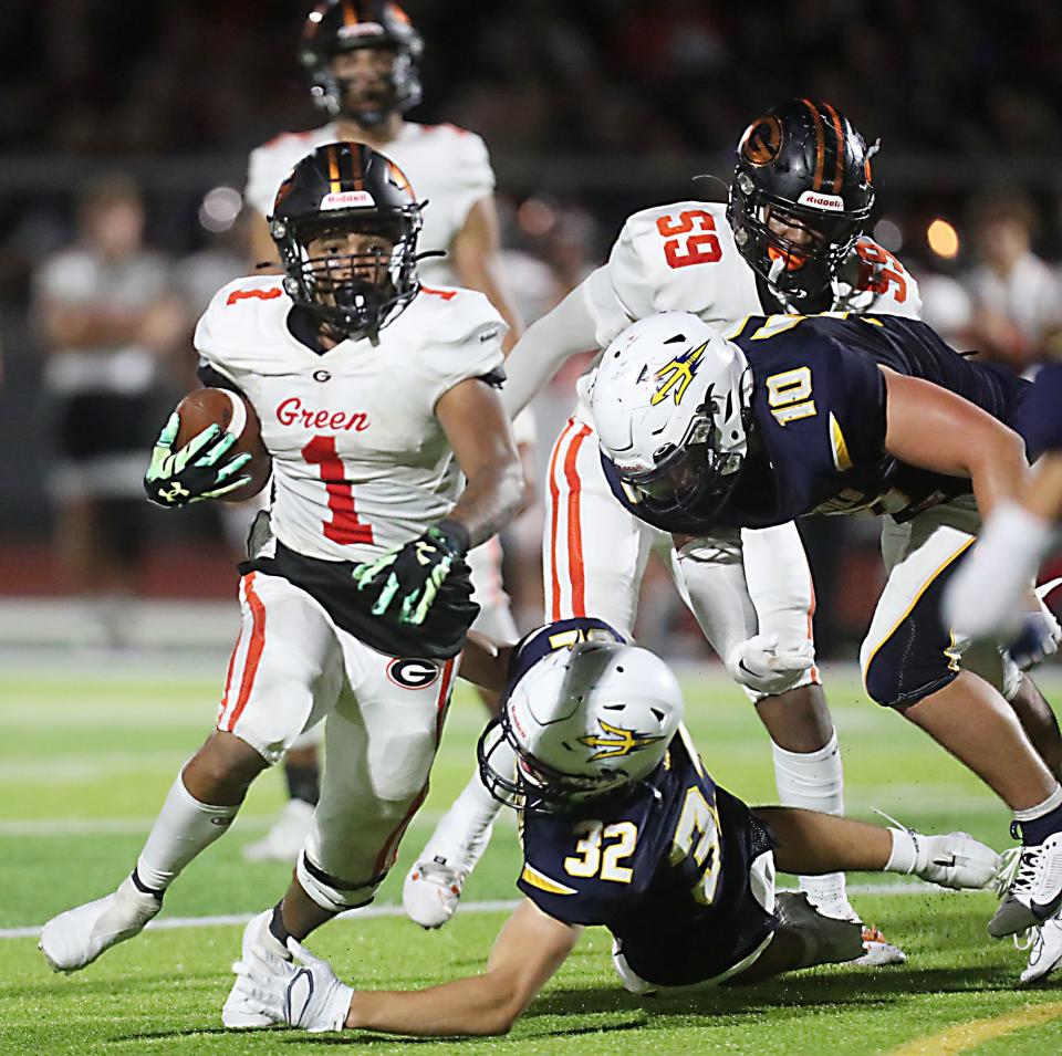 Green's Antonio Martin tries to break away from Tallmadge's Santino Cuva and Cooper Jones in the second half, Friday, Sept. 1, 2023.