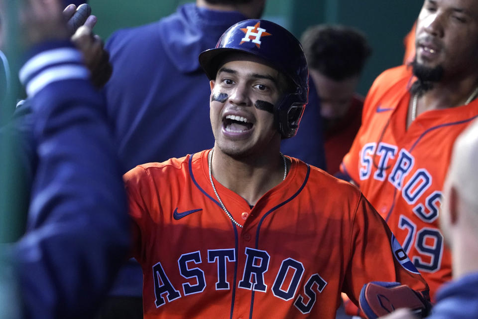 Houston Astros' Mauricio Dubón celebrates with teammates after scoring on a Yordan Alvarez double in the fourth inning against the Kansas City Royals during a baseball game Tuesday, April 9, 2024, in Kansas City, Mo. (AP Photo/Ed Zurga)