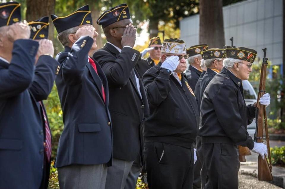 Members from VFW Post 318 and American Legion Post 100 salute during Lacey Veterans Services Hub grand opening in Lacey. There is a Veteran/Community Council meeting Friday, Jan. 27.