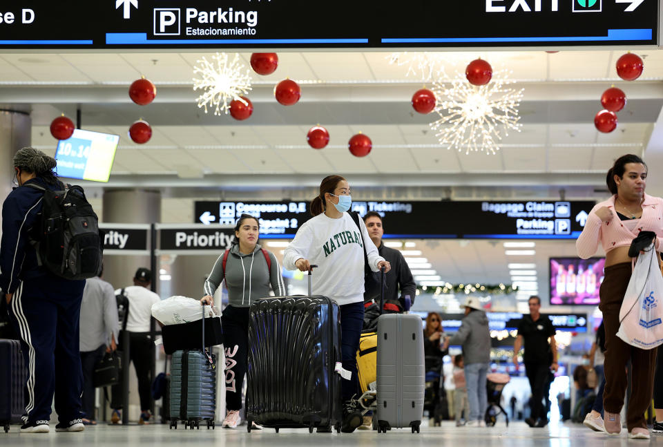 Travelers walk through Miami International Airport in Miami  (Joe Raedle / Getty Images)