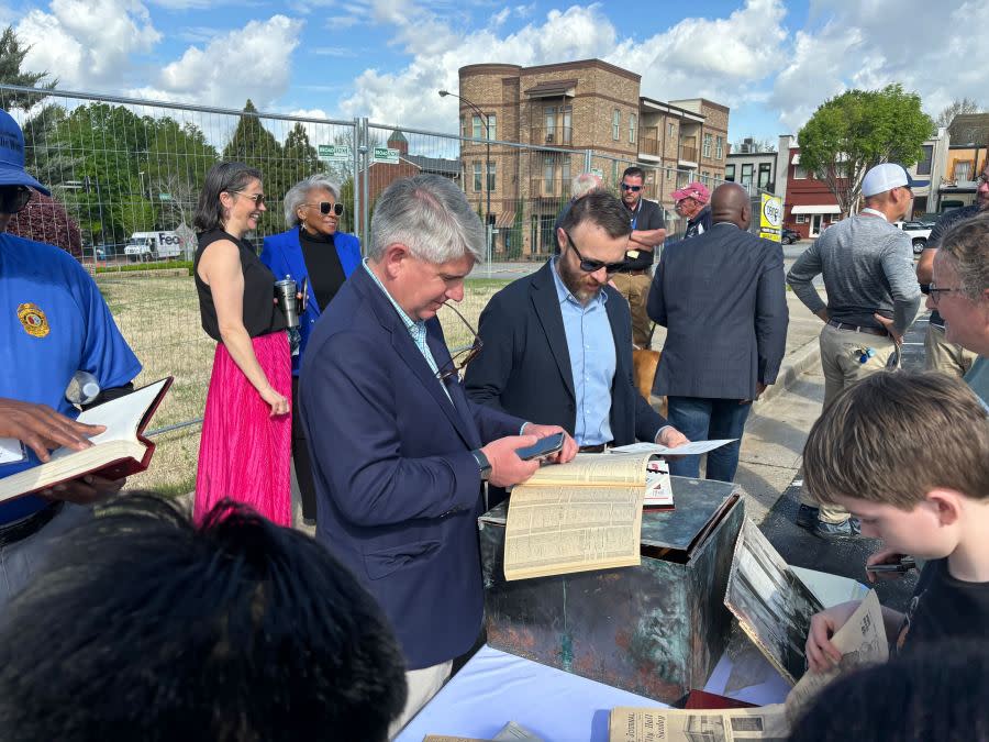 Residents look through items in the time capsule. 