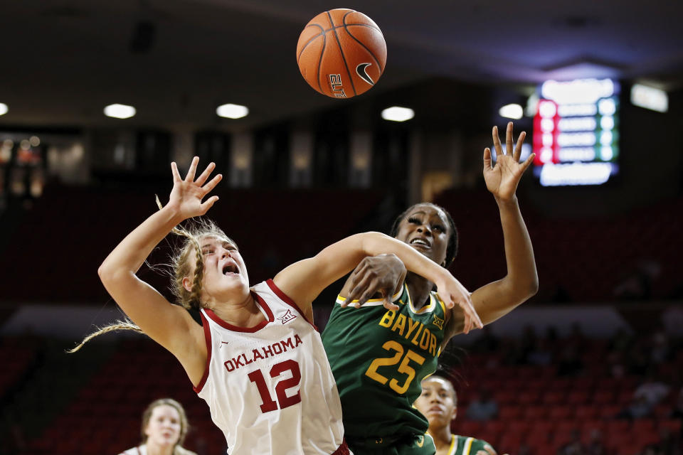 Baylor center Queen Egbo (25) knocks the ball away from Oklahoma guard Gabby Gregory (12) in the first half of an NCAA college basketball game in Norman, Okla., Saturday, Jan. 4, 2020. (AP Photo/Sue Ogrocki)