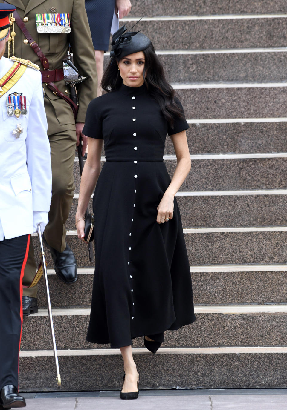 <p>Meghan wore a custom made black Emilia Wickstead dress with a Philip Treacy hat, a satin Givenchy clutch and Tabitha Simmons slingback pumps for the official opening of the extension of the ANZAC Memorial in Hyde Park in Sydney, Australia. <em>[Photo: Getty]</em> </p>