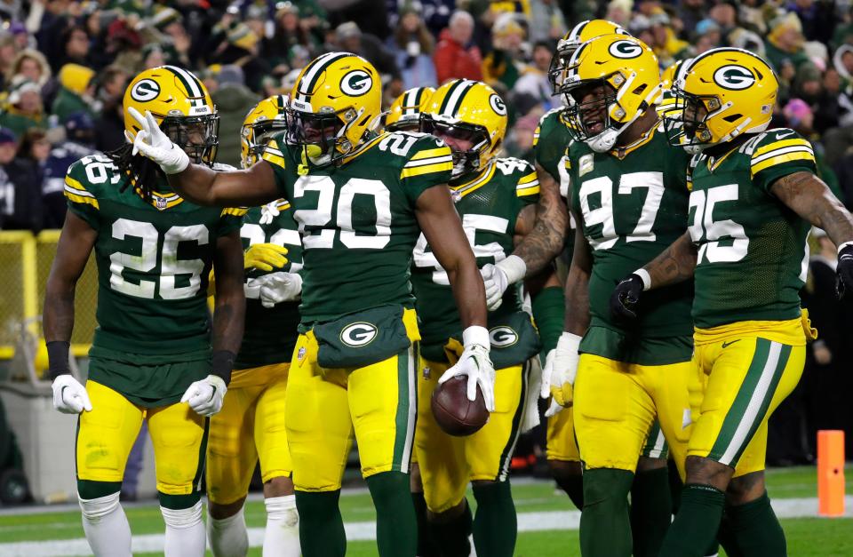 Green Bay Packers safety Rudy Ford (20) celebrates after getting his second interception against the Dallas Cowboys during their game Sunday, Nov. 13, at Lambeau Field in Green Bay.