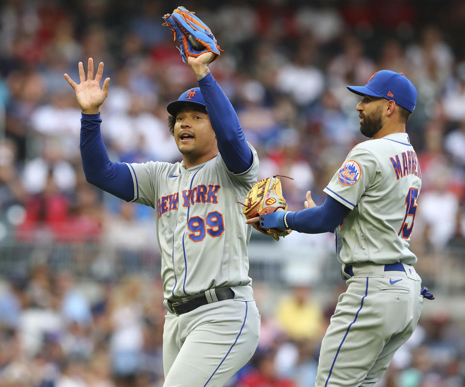 New York Mets starting pitcher Taijuan Walker catches a popup from Atlanta Braves' Matt Olson in front of Deven Marrero during the first inning of a baseball game Tuesday, Aug. 16, 2022, in Atlanta. (Curtis Compton/Atlanta Journal-Constitution via AP)