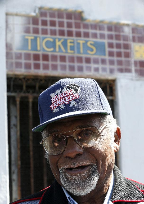 Robert "Bob" Scott, who once played for the New York Black Yankees of the Negro League baseball league stands outside of Hinchliffe Stadium, Wednesday, April 16, 2014, in Paterson, N.J. Hinchliffe Stadium in Paterson was once home to the New York Black Yankees, the New York Cubans and other Negro League baseball teams. Eleven members of the National Baseball Hall of Fame played there, including Larry Doby. The crumbling Art Deco stadium was granted national historic landmark status in 2013. Lawmakers are pushing to designate it as part of the nearby Great Falls National Historical Park. (AP Photo/Julio Cortez)