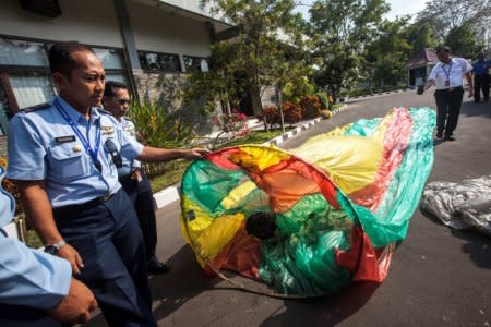 Officers show an unmanned hot air balloon, used in traditional festivities for celebrating Eid al-Fitr, during a press conference at  AirNav Indonesia, in Yogyakarta , Indonesia June 16, 2018 in this photo taken by Antara Foto. Antara Foto/ Andreas Fitri Atmoko/via REUTERS