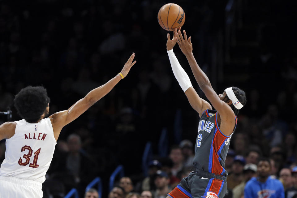 Oklahoma City Thunder guard Shai Gilgeous-Alexander shoots over Cleveland Cavaliers center Jarrett Allen during the first half of an NBA basketball game Friday, Jan. 27, 2023, in Oklahoma City. (AP Photo/Nate Billings)