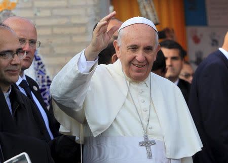 Pope Francis waves while visiting the Banado Norte neighborhood in Asuncion, Paraguay, July 12, 2015. REUTERS/Lucas Nunez