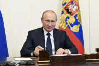 Russian President Vladimir Putin, attends a meeting via teleconference at the Novo-Ogaryovo residence outside Moscow, Russia, Monday, June 1, 2020. Putin set a nationwide vote on constitutional amendments allowing him to extend his rule for July 1. (Alexei Nikolsky, Sputnik, Kremlin Pool Photo via AP)