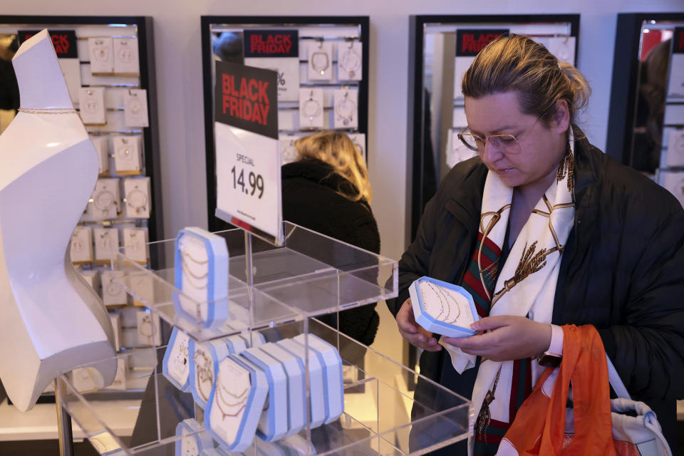 Customers shop in a nearly-empty Macy's early on Black Friday, Nov. 25, 2022, in New York. (AP Photo/Julia Nikhinson)