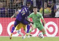 Orlando player Benji Michel, left, scores a goal past San Jose goalkeeper J.T. Marcinkowski, right, during a MSL soccer match in Orlando, Fla., on Tuesday, June 22, 2021. (Stephen M. Dowell /Orlando Sentinel via AP)